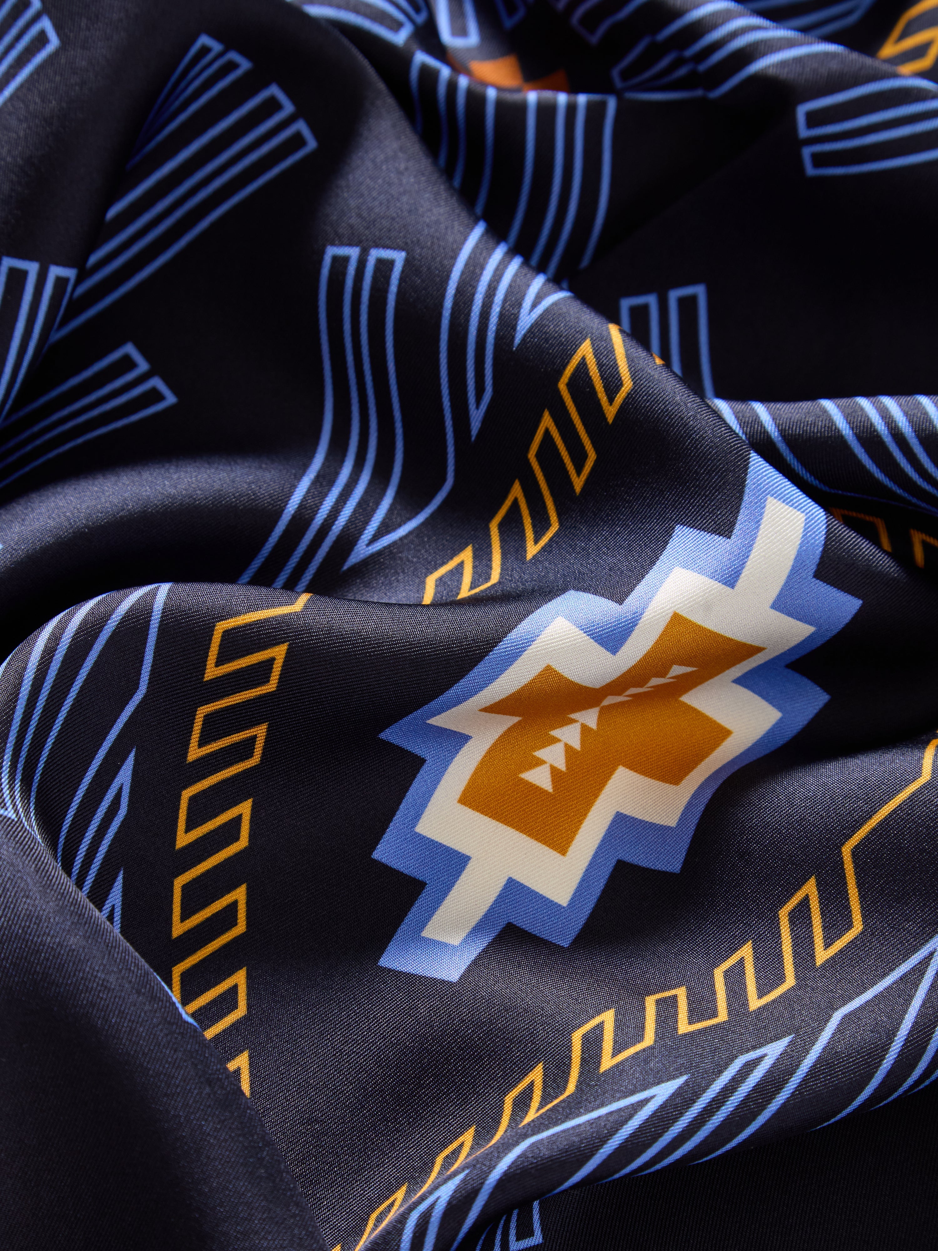 We Norwegians | FW25 | Pioneer Silk Scarf_Navy blue | Scarf with printed motifs | Photograph showing the fabric and print details