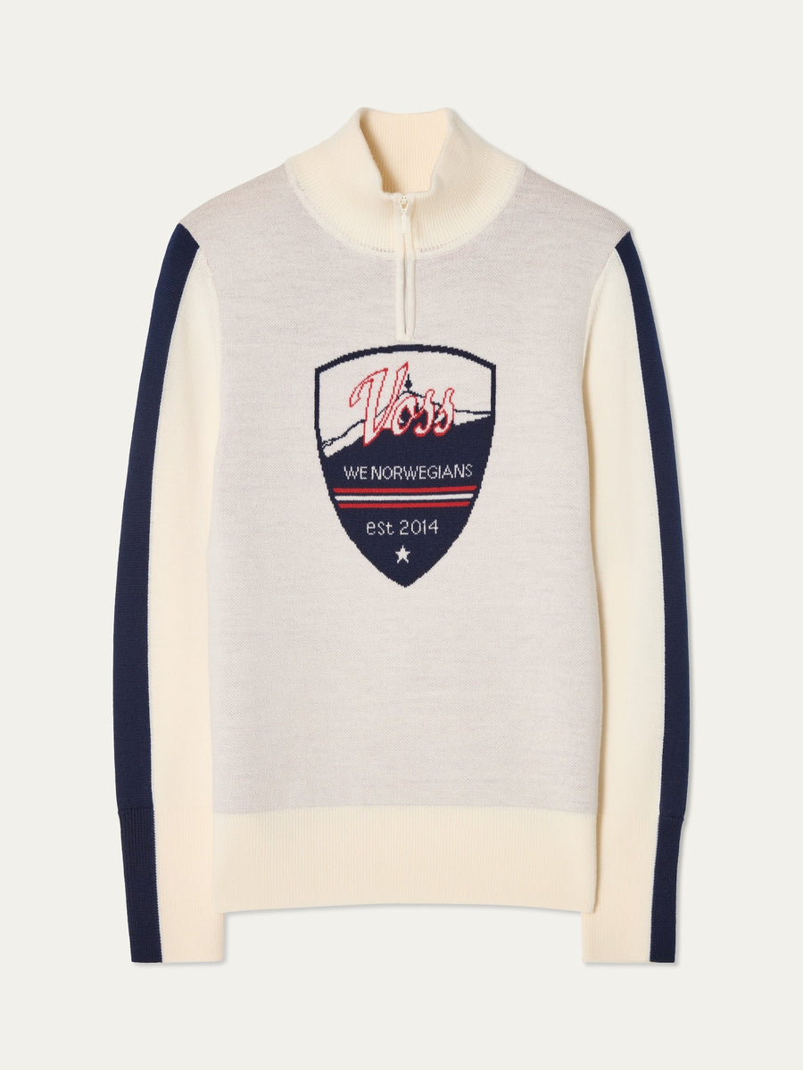 We Norwegians | FW25 | Womens Afterski zip-up in cream with logo and 1/4th zipper in the front. Shot against an off white background